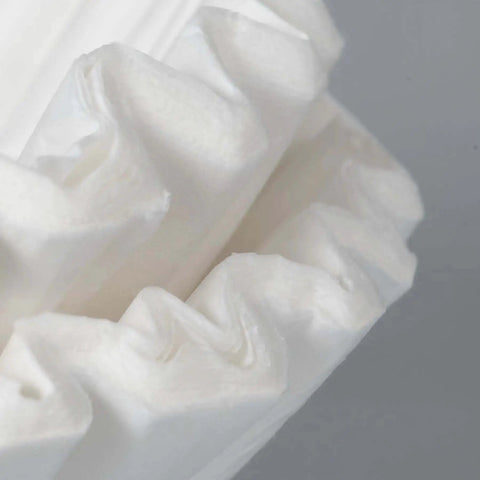 Close-up of paper coffee filters for Commercial Tea And Paper Coffee Filters 1.5 Gallon White 500 Count For Use With Specialty Commercial Brewers.