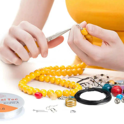 Person using All In One Jewelry Making Kit With Fifteen Jewelry Findings, Brass Ring, Beading Wires, Pliers And Tweezers