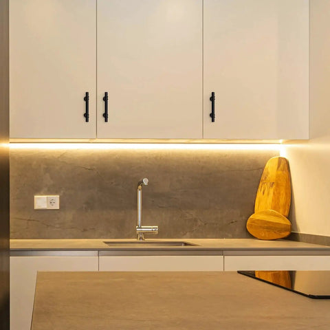 Modern kitchen with white cabinets featuring 30 Pack 5 Inch Matte Black Cabinet Pulls With Round Base For Kitchen Cabinets And Drawer Fronts.