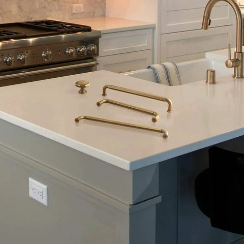 Six Pack Antique Brass Zinc Alloy Cabinet Pulls With 5 Inch Hole Center displayed on kitchen counter