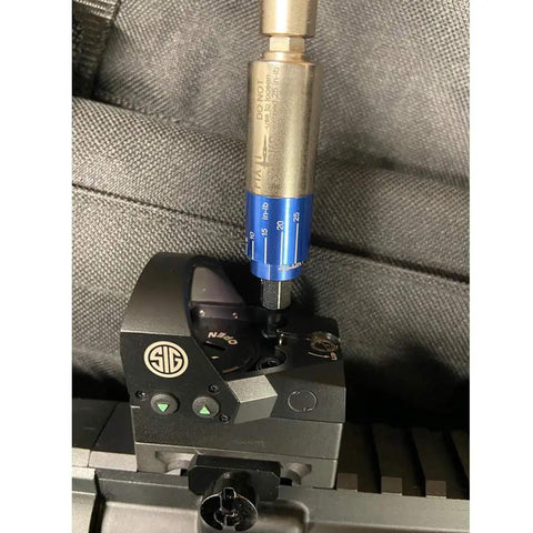 Close-up of an All In One Torque Driver For Field Use By Fix It Sticks With A 6 To 25 Inch Pounds Range And Plus Minus Ten Percent Accuracy Mini Model tightening a tactical gear mount.