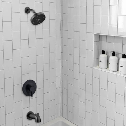 Matte black shower and tub trim kit installed on white tiled wall with Moen Posi Temp valve.