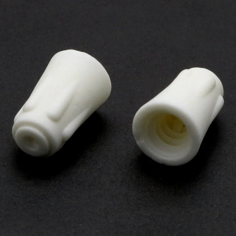 Two white ceramic twist-cap wire connectors for high-heat 22-10 AWG electrical wiring.
