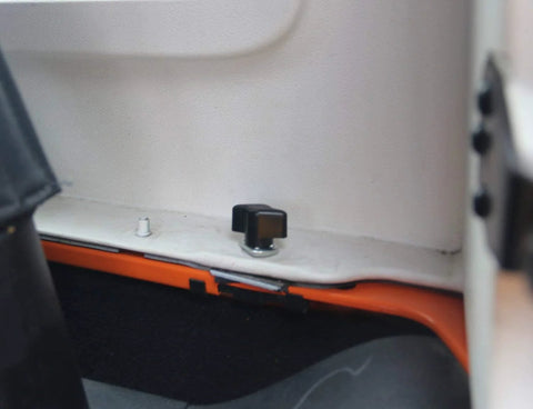 Close-up of No Tools Needed Hard Top Removal Fastener Kit with nylon thumb screw and zinc stud nut installed on Jeep Wrangler