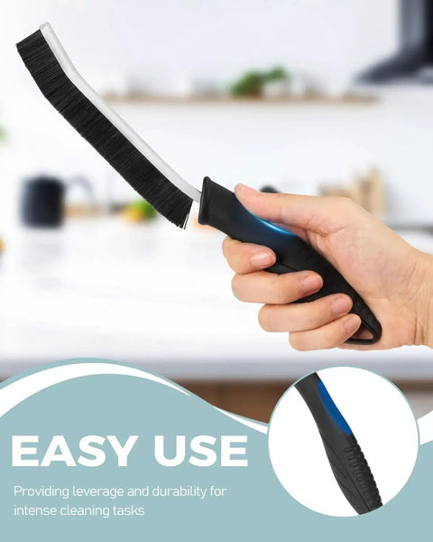 Person holding Hard Bristle Crevice Cleaning Brush For Grout And Tight Gaps Non Slip Handle against blurred kitchen background