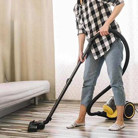 Person using Miele Vacuum Handle Grip Tube Replacement For 35 Mm And 47 Mm Diameters with upright vacuum in living room.