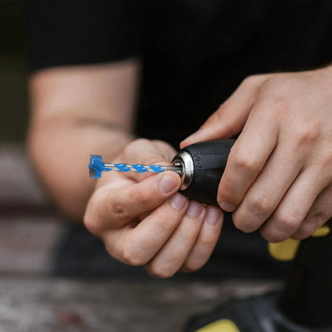 Person holding a blue Hard Alloy Woodworking Drill Bit 25x125mm Extended Thread Hole Opener for heavy duty wood drilling.