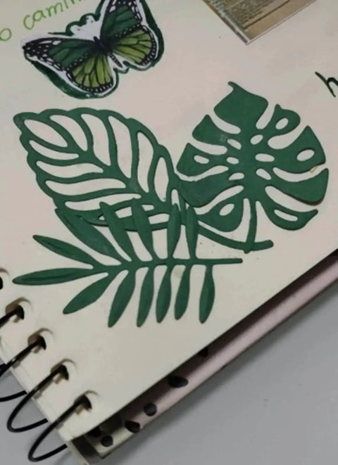 Totally Seven Piece Leaf Die Cut Set For Scrapbooking And Card Making, green leaf shapes on scrapbook page with butterfly accent