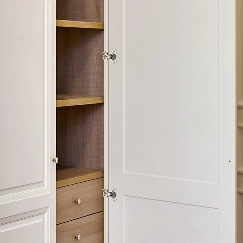 Home Expert 1/2-inch overlay satin-nickel concealed cabinet hinge on white face-frame doors; left door open.
