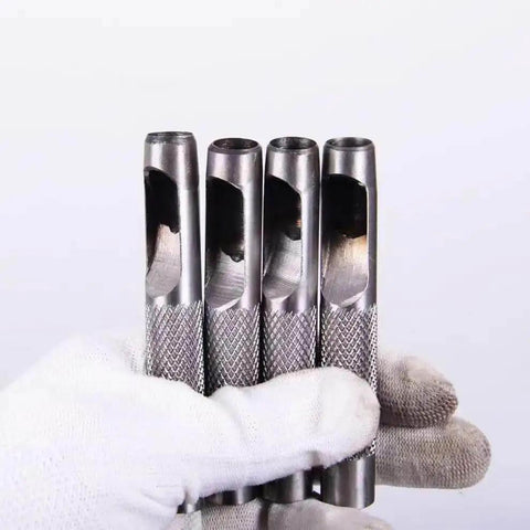 Three-Piece Grommet Hole Punch Set For Leatherworking, Heavy Duty Steel Hollow Punches held in gloved hand, showing detailed steel texture.