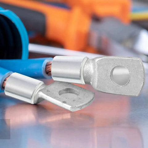Close-up of heavy-duty battery cable terminals on a reflective surface with blurred background, showcasing metal components and insulation.
