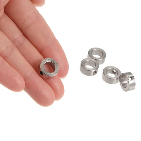 Hand holds 10 Piece Set Screw Shaft Collars Kit With 7.05mm Bore, 12mm Outer Diameter, 5mm Thickness, Nickel Plated Carbon Steel.