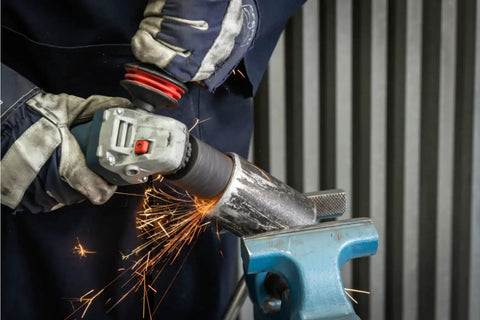 Worker using Beast Mode Heavy Duty 2-Inch By 3-Inch Type 18 Grinding Plug With 16 Grit Aluminum Oxide on metal pipe in a vise