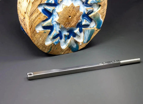 Carbide Turning Tools Set For Acrylic Resin And Hybrid Wood Lathe Work With 12 Inch Tools And 17 Inch Handles Four Piece USA Made Lathe Tool Kit next to a turned piece of wood with blue resin