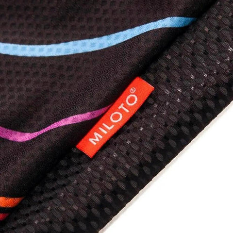 Close-up of Miloto black fabric with multicolor lines and red tag