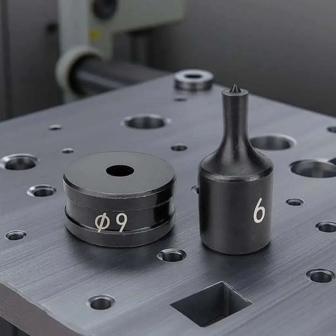 Chrome steel dies from 30 Piece Hydraulic Hole Punch Die Set For CH70 And CH70L on metal surface, sizes 9 and 6 visible