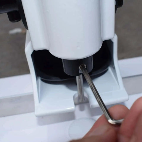 Adjusting Heavy Duty Portable Handheld Paper Hole Punch With 4mm 5mm 6mm 7mm 8mm Holes using a tool, close-up view