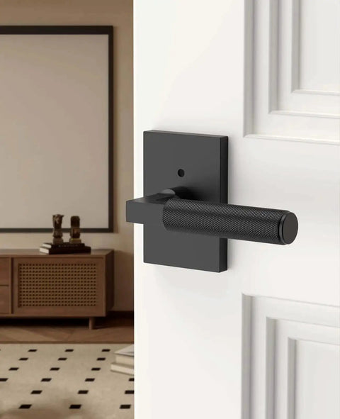 Black Privacy Door Handle Set With Keyless Interior Lock installed on a white door, featuring an easy privacy button for bedrooms.