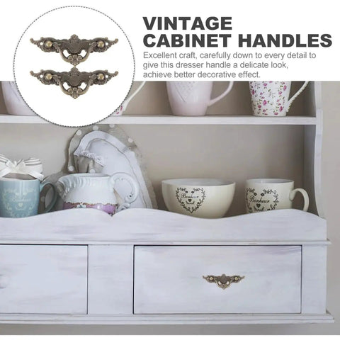 Vintage Cabinet Handles 4.33 Inch Antique Brass Drawer Pulls on white dresser with decorative cups and teapots.