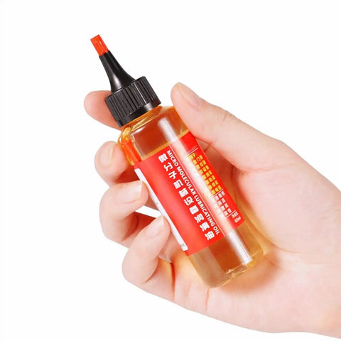 Hand holding a 60ml bottle of door hinge lubricant penetrating oil for no more squeaks and rust prevention, multi purpose lubricant for fans.