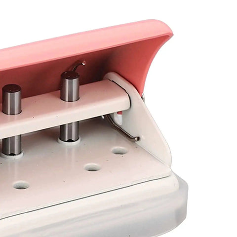 Close-up of Pink Handheld 3 Hole Paper Punch for Binders, showing punch mechanism with clean 5.5mm holes