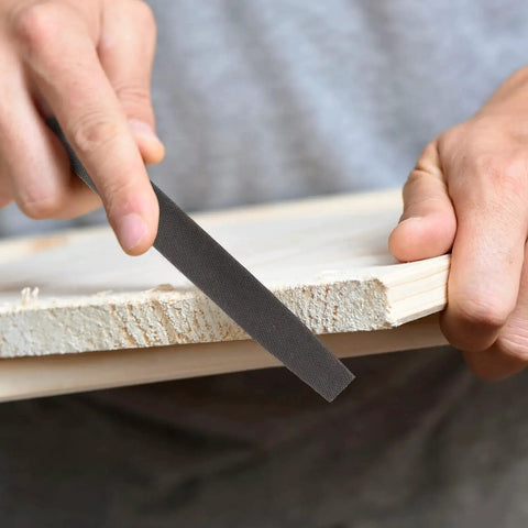 6 Inch Flat Hand File With Double Cut Teeth For Metal And Wood Shaping Deburring And Smoothing Edges High Carbon Steel Durable Single Hand Tool Without Handle For Professional And Hobby Use being used to smooth a wooden edge.