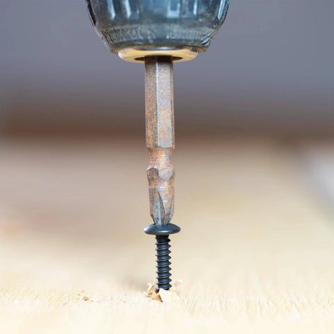 Close-up of a drill driving a Beefy Set Of 100 8 By 1 Inch Wood Screws Self Tapping Truss Head Phillips Stainless Steel 304 Black Oxide.