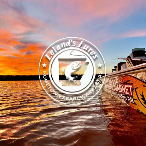 Boat on water at sunset with Leland's Lures logo, promoting Crappie Magnet Best Of The Best Kit For Crappie Fishing With 96 Bodies