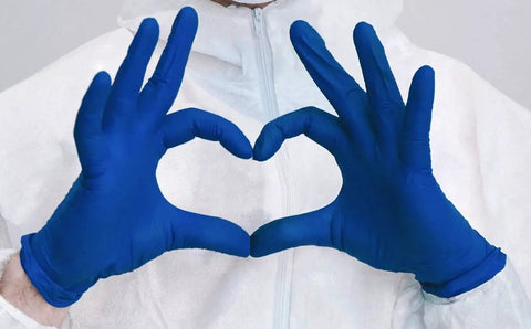 Person wearing Cobalt Blue Nitrile Examination Gloves Latex Free Medical Grade 4.5 Mil forming a heart shape with hands