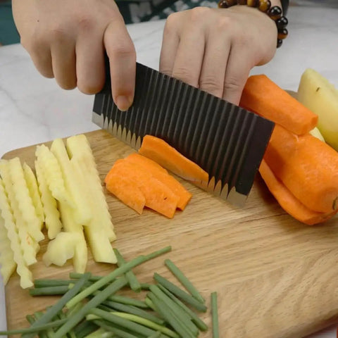 Person using Stainless Steel Crinkle Potato Cutter And Wavy Vegetable Slicer Kitchen Chopper For French Fries And Scalloped Potatoes Easy To Use No Fuss Durable And Compact Kitchen Tool For Home Chefs on carrots