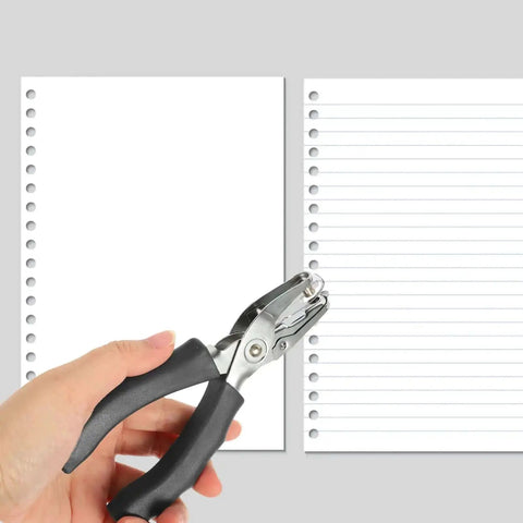 Hand holding Metal Single Hole Puncher With Ergonomic Handles And Built In Guide For Home Office Crafts against paper