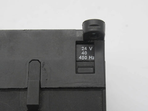 Close-up of Miniature 3-pole contactor B7-30-10-01 with 24V coil, showing voltage marking on compact industrial control relay.
