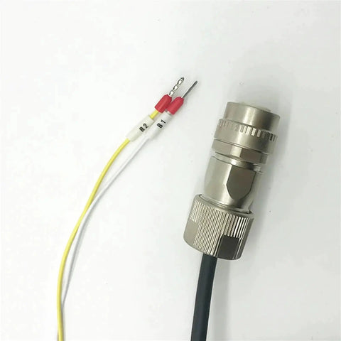 Close-up of a metal circular connector with knurled lock and black cable; yellow and white wires with red caps labeled B1/B2.