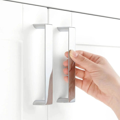 10 Pack 5 Inch Polished Chrome Cabinet Pulls being installed on a white kitchen cabinet door with 128mm hole centers