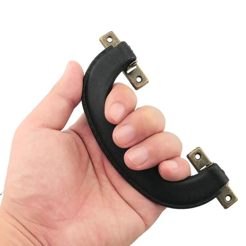 Hand holding 4 Pieces Vintage Style Luggage Handle Fittings In Black Leather And Plastic Replacement Hardware for Suitcases