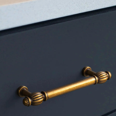 Antique brass cabinet pull on dark cabinet; focus on Six Pack Antique Brass Cabinet Pulls in Zinc Alloy for Kitchen and Furniture.