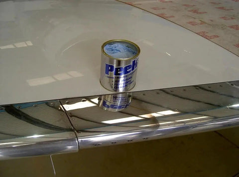 Multipurpose All In One Metal Cleaner And Polish For Chrome Aluminum Silverware Glass And Fiberglass Cleans Shines And Protects All Metals Fiberglass And Acrylics Home And Industrial Use 1000ml Can shown on polished surface.