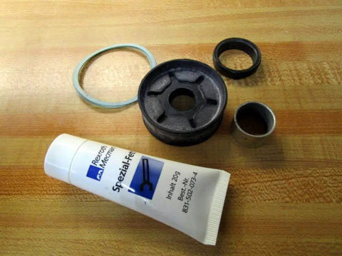 523 200 000 2 Repair Kit with Lubricating Grease 831-502-073-4 for linear slide unit, shown with parts on a wooden surface.