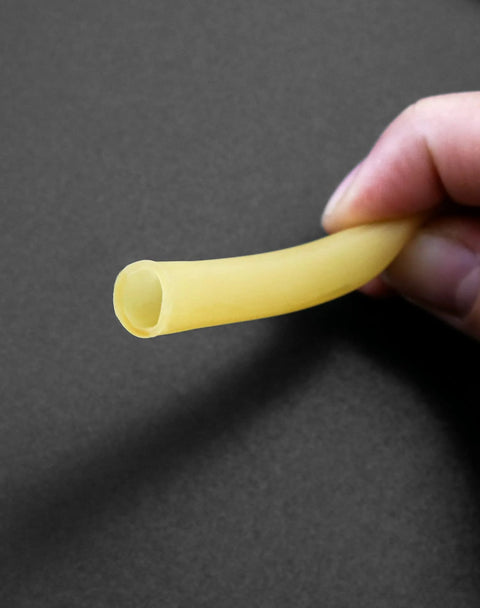 QWORK latex rubber tubing, yellow, 3/8 in OD × 1/4 in ID, held by fingers