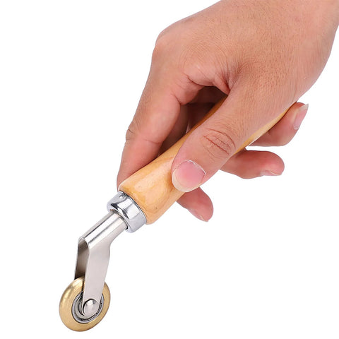 Seam roller with wooden handle, steel neck and brass wheel for roofing membranes