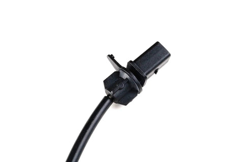 Front view of black disc brake pad wear sensor with rectangular electrical connector and cable