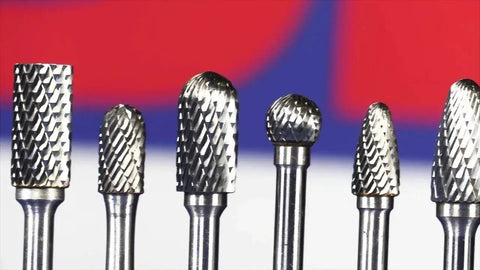 Carbide Ball End Double Cut Burr for Die Grinder, Three Quarters Inch Diameter, Eleven Sixteenths Inch Cut Length, One Quarter Inch Shank, Two and Seven Sixteenths Inches Overall Length, DUL Series Drill America, with other burrs in background.