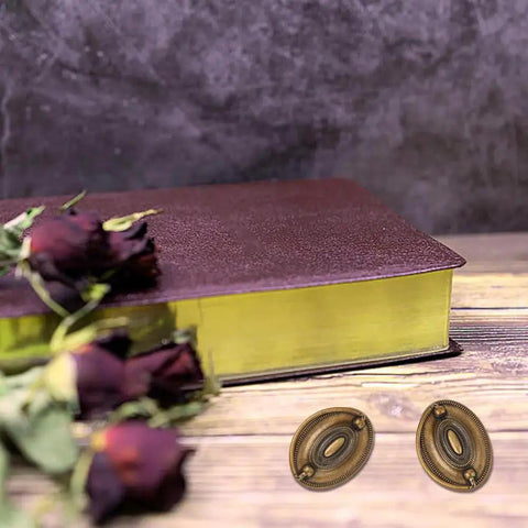 Six Pcs Oval Retro Brass Drop Swing Furniture Drawer Pulls With Screws Antique Bronze Finish next to closed book and dried roses.