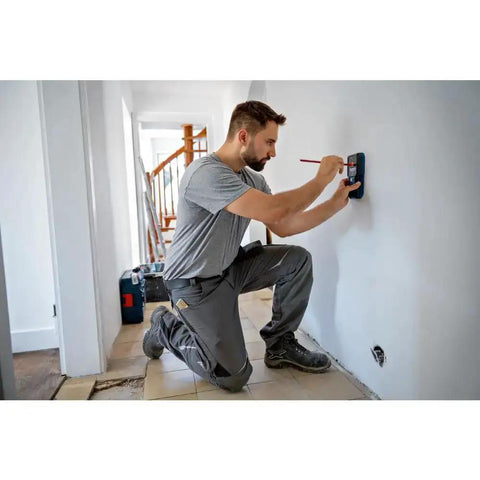 Electrician uses Pro Grade Wall Scanner For Electricians And Contractors All In One Multi Function Stud Finder on wall