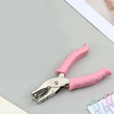 6mm Handheld Single Hole Punch For Paper With Durable Metal Body And Rubber Grip Handle on desk with paper clips