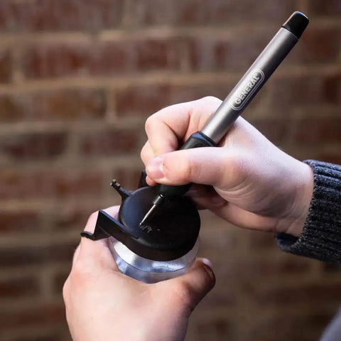 Person using Cordless Engraving Pen For Metal With Diamond Tip Etching Tool Dope For Toys, Sporting Goods, Glass Gifts And More.