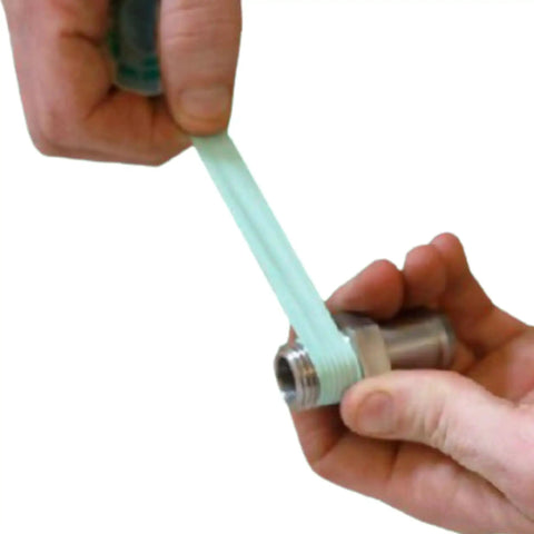 Person applying Pro Grade Green Oxygen PTFE Thread Seal Tape Gas Pipe Sealant For Oxygen Lines 1/4 Inch By 260 Inch O2 Rated on metal pipe