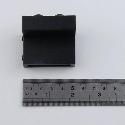 Top view of a Four Pack Black Barn Door Roller Stopper Hardware For 1.61 Inch By 0.28 Inch Track And 41 By 7 Millimeter Rails with ruler.