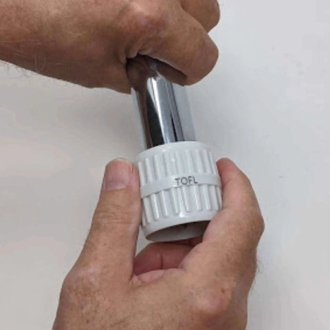 Hands using a stainless steel pipe reamer tool for quick deburring and reaming, durable metal build, on a chrome pipe.