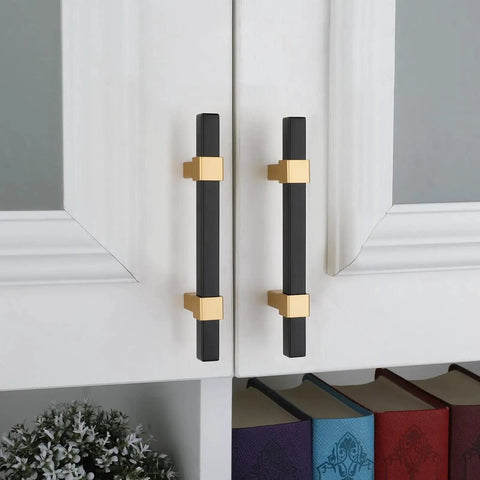 10 Pack 3 Inch Matte Black And Brass Cabinet Handles installed on white cabinet doors